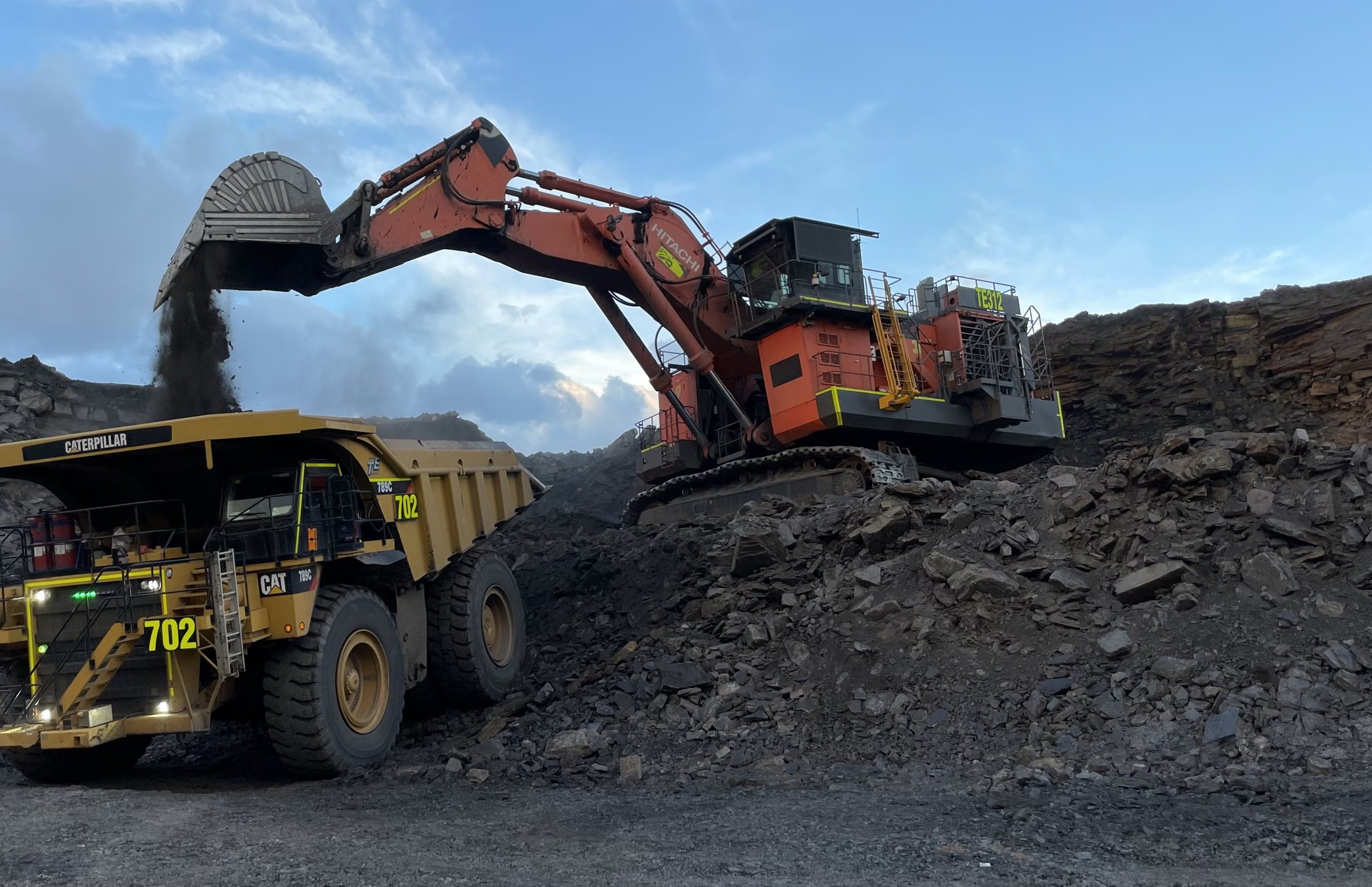 Hydraulic excavator loading overburden